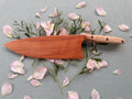 Blacklined cherry serving knife.